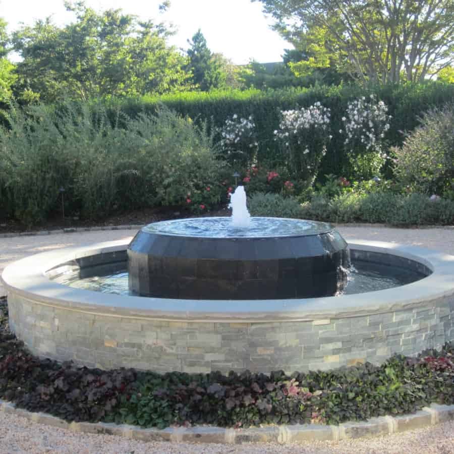 Gunite fountain with East West Stone veneer, Black Slate tile spill over, and rock faced Bluestone caps - Southampton, Long Island NY