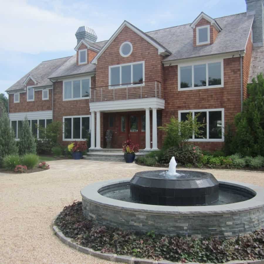Gunite fountain with East West Stone veneer, Black Slate tile spill over, and rock faced Bluestone caps - Southampton, Long Island NY