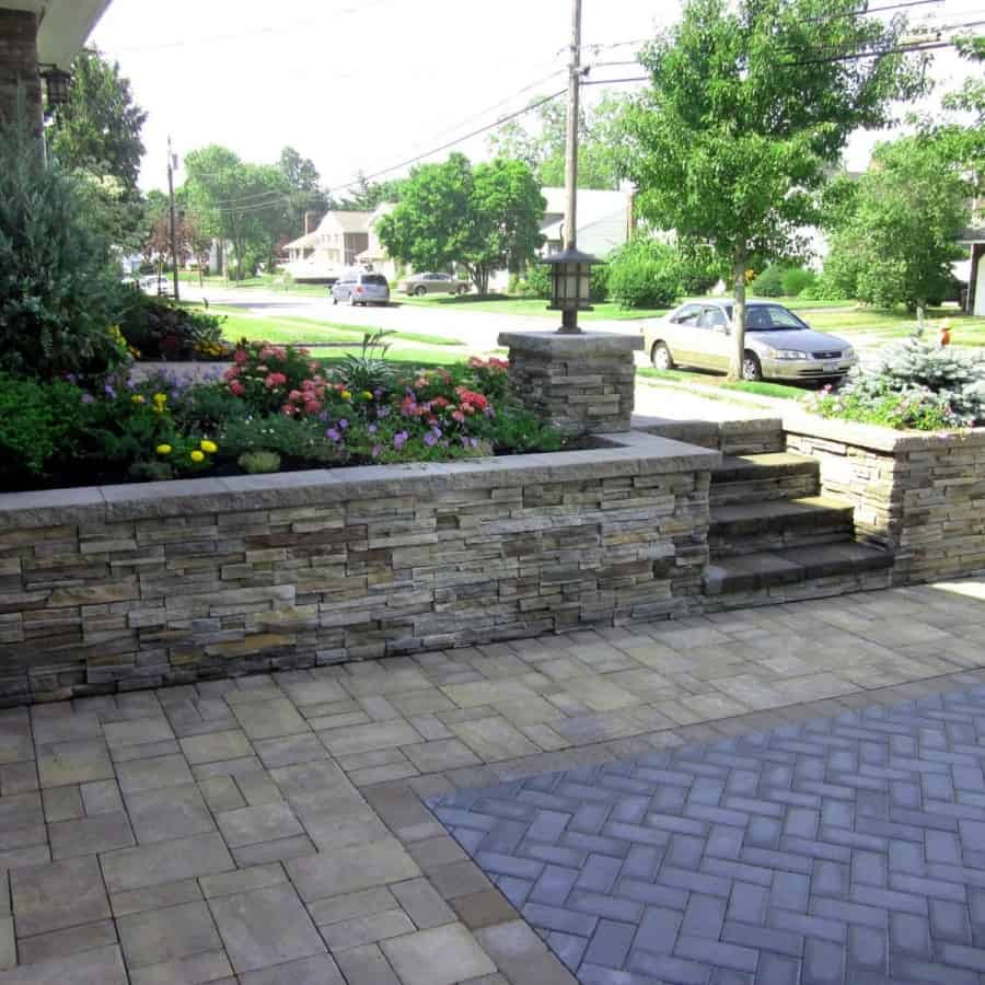 Retaining Wall with Cultured Stone Pro-Fit–Alpine Ledgestone. Color: Pheasant. Capped with Cambridge Splitface Wall cap Toffee/Onyx-color - Massapequa, Long Island NY