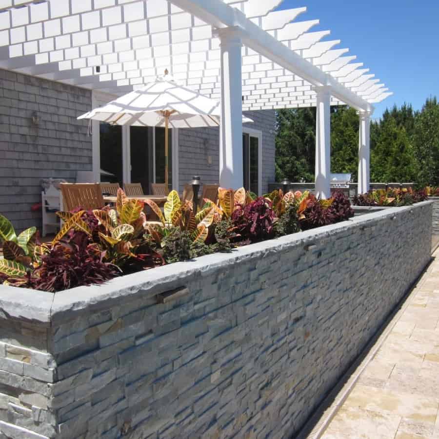 Custom Planters veneered with East West Stone - Bayside Waters - with Rockfaced Bluestone Cap planted with Coleus and Croton - Southampton, Long Island NY