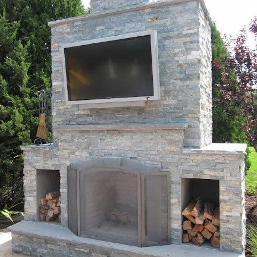 Outdoor Fireplace with Outdoor Television veneered in East West Stone - Bayside Waters - Southampton, Long Island NY