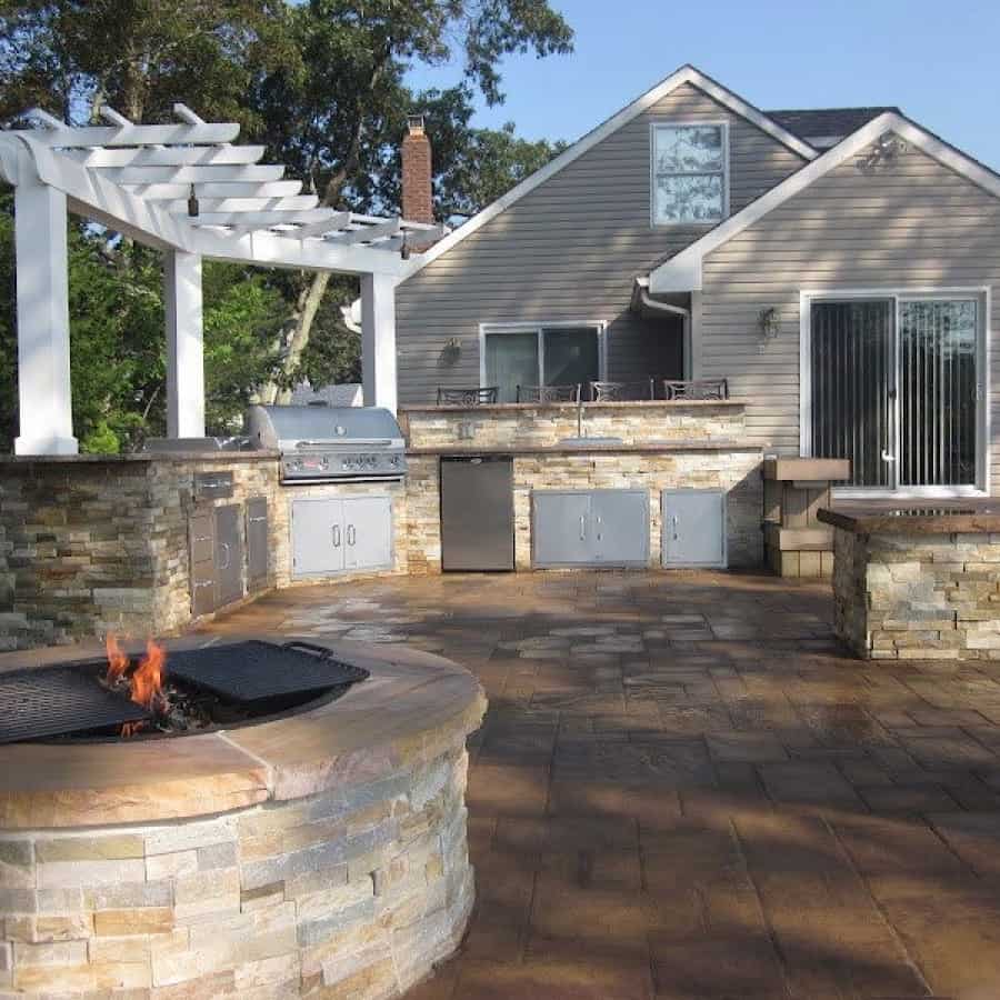 Outdoor Kitchen and Fire Pit Veneered with East West Stone - Honey Gold - and capped with Rainbow Stone with rock faced edge - Flanders, Long Island NY