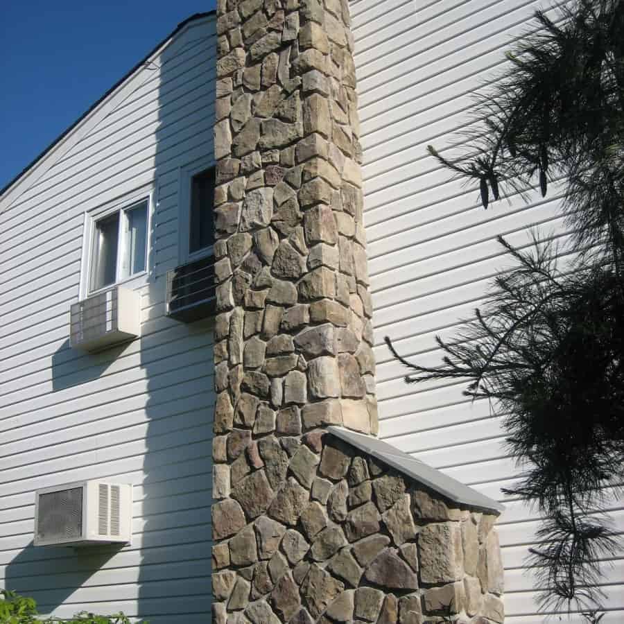 Chimney veneered in Cultured Stone Dressed Fieldstone - Bucks County - with Thermal Bluestone cap - Dix Hills, Long Island NY