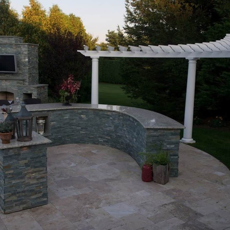 Outdoor Fireplace veneered with East West Stone - Bayside Waters - with Bluestone accents - Outdoor Flatscreen TV mounted on smoke chamber - Southampton, Long Island NY